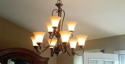 Classic ceiling chandelier installation with warm lighting in Cleveland, OH