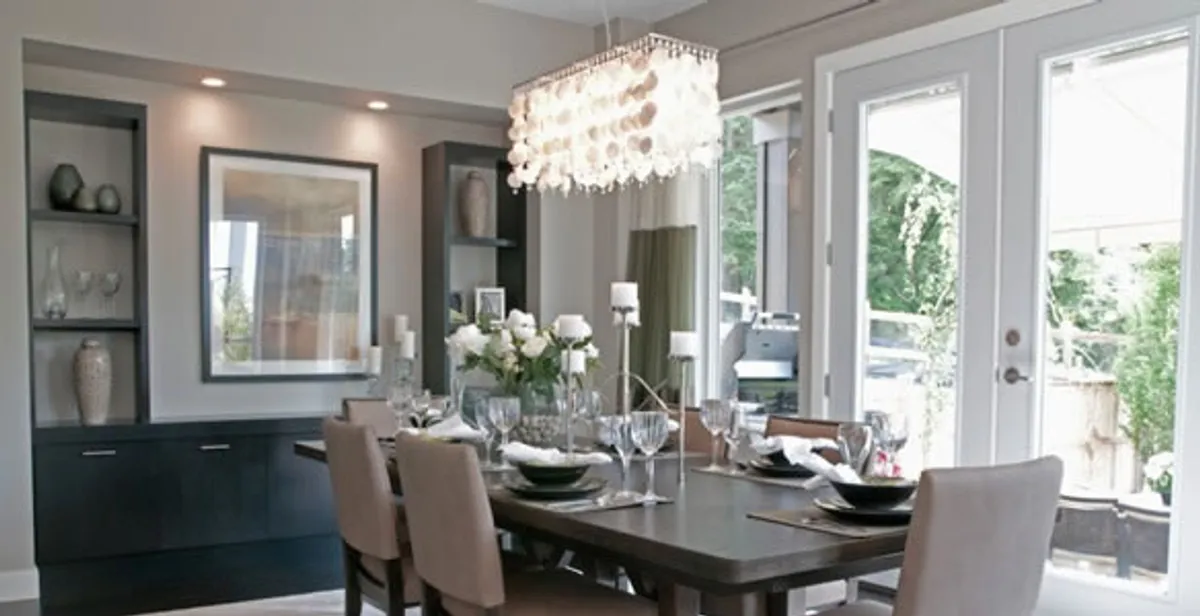 Elegant dining room chandelier installation above table in Cleveland, OH