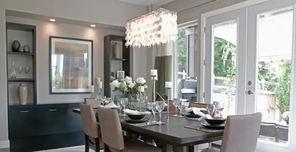Elegant dining room chandelier installation above table in Cleveland, OH