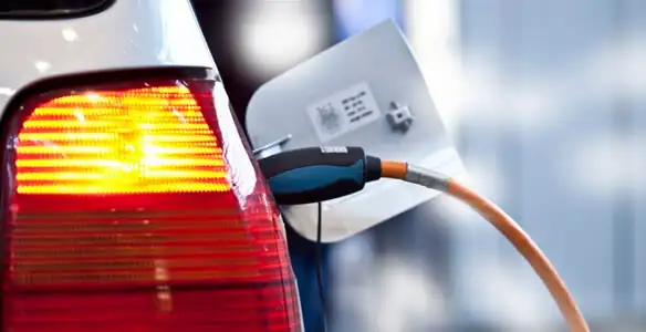 Electric car plugged into EV charger after professional installation in Cleveland, OH