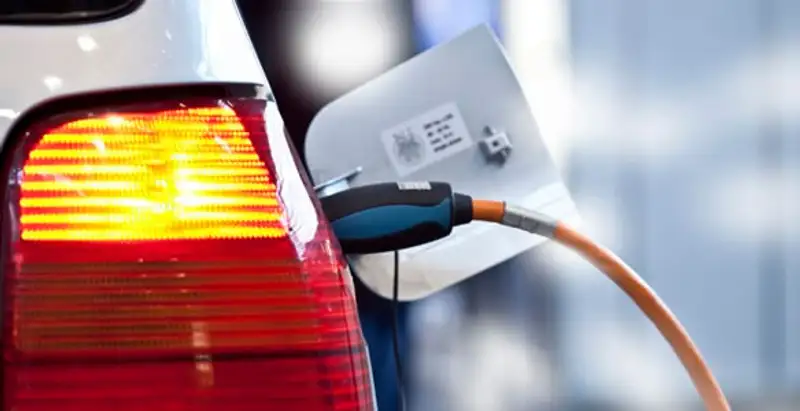 Electric car plugged into EV charger after professional installation in Cleveland, OH