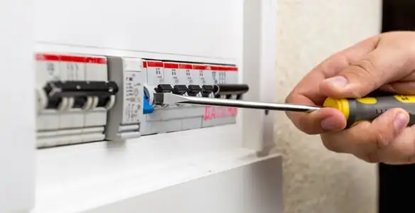 electrical panel upgrade service showing technician adjusting circuit breakers during system upgrade in Cleveland, OH