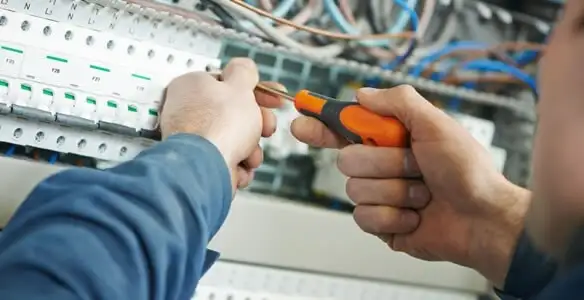 electrical service showing licensed electrician performing electrical panel maintenance and adjustments in Cleveland, OH