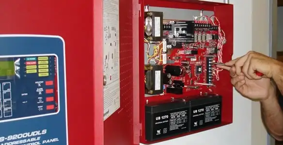 fire alarm installation service showing technician configuring fire alarm control panel in Cleveland, OH