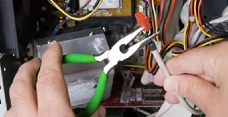 Licensed electrical contractor performing electrical repair with tools in Lakewood, OH