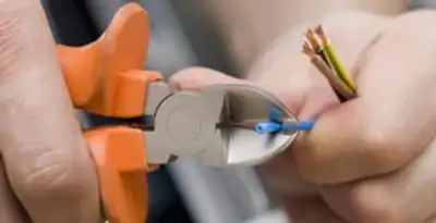 professional electrical services showing precise wire cutting by licensed electricians in Cleveland, OH