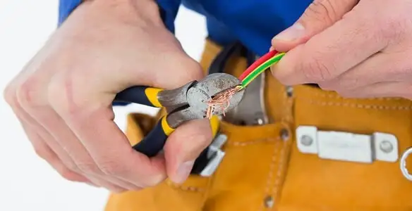 licensed electrician securing electrical wiring with professional tools during service work in Cleveland, OH