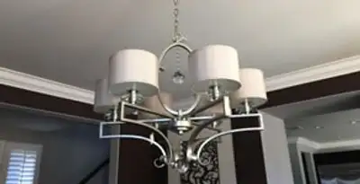 Modern chandelier installation with multiple light fixtures in Cleveland, OH
