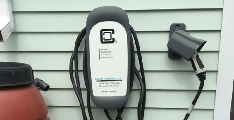 Outdoor electric vehicle charger installation on residential wall in Cleveland, OH